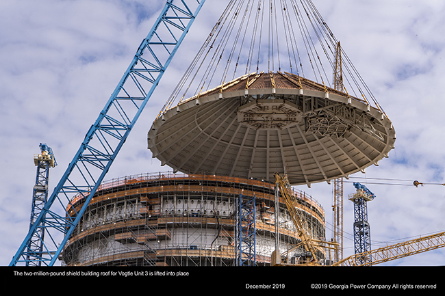 The two million pound shield building roof for Vogtle Unit 3 is lifted into place